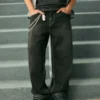 Gewaschene schwarze Baggy-Jeans mit Schlangenstickerei