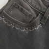 Hoch geschnittene, gewaschene schwarze Jeans mit Stickerei und ausgestelltem Bein