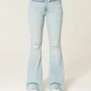Hoch geschnittene, leicht verwaschene Flare-Jeans mit Rissen